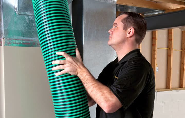 a man holding an air duct