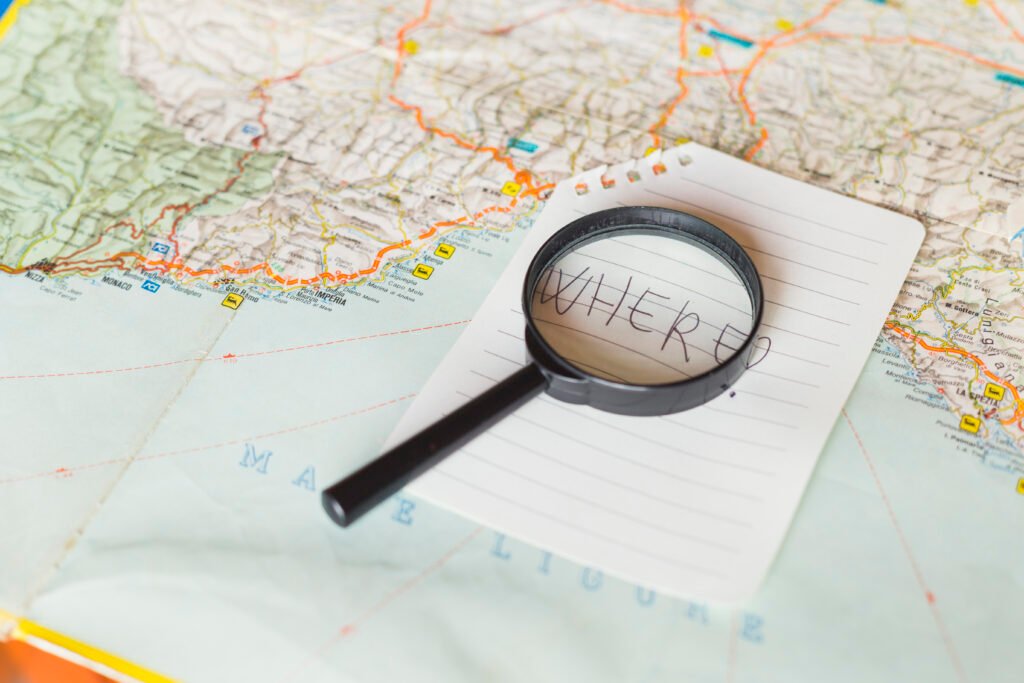 a map with magnifying glass above the paper