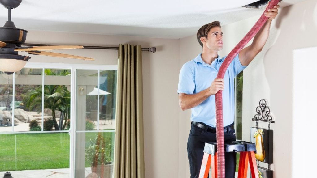 Air Duct Cleaning Stamford CT a man in a ladder