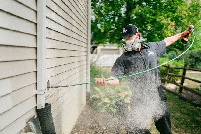 a man cleaning a vent with overflowing dust in it