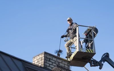 a man sweeping a chimney above the roof